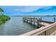 Wooden dock extending over calm water, offering serene waterfront views at 1260 Dolphin Bay Way # 303, Sarasota, FL 34242