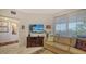 Bright living room with comfortable seating and large window at 1260 Dolphin Bay Way # 303, Sarasota, FL 34242