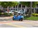 A blue three-wheeled car driving on Siesta Key at 1260 Dolphin Bay Way # 303, Sarasota, FL 34242