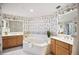 Large bathroom with double vanity and bathtub at 1280 Dolphin Bay Way # 202, Sarasota, FL 34242