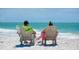 Couple enjoying the view from beach chairs on Siesta Key at 1280 Dolphin Bay Way # 202, Sarasota, FL 34242