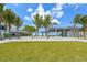 Siesta Beach park with grassy area, palm trees and shaded seating at 1280 Dolphin Bay Way # 202, Sarasota, FL 34242