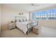 Primary bedroom with water views and neutral decor at 1280 Dolphin Bay Way # 202, Sarasota, FL 34242