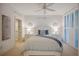 Serene bedroom with a white bed frame, blue bedding, and plantation shutters at 1280 Dolphin Bay Way # 202, Sarasota, FL 34242