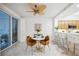 Bright breakfast nook with a round table and stylish mustard-colored chairs at 1280 Dolphin Bay Way # 202, Sarasota, FL 34242