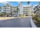 Condo building with parking and lush landscaping at 1280 Dolphin Bay Way # 202, Sarasota, FL 34242