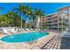 Enjoy the refreshing pool at Dolphin Bay, surrounded by lush tropical landscaping at 1280 Dolphin Bay Way # 202, Sarasota, FL 34242