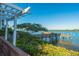 Serene waterfront view with private dock and lush landscaping at 1280 Dolphin Bay Way # 202, Sarasota, FL 34242