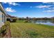 Backyard with pond view, lush grass, and flowers at 12915 True Blue Cir, Bradenton, FL 34211