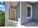 Front entry with yellow door and gray siding at 12915 True Blue Cir, Bradenton, FL 34211