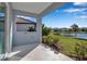 Covered patio overlooking a pond and landscaped lawn at 12915 True Blue Cir, Bradenton, FL 34211