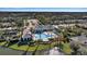 Aerial view of community pool and clubhouse near lake at 12915 True Blue Cir, Bradenton, FL 34211