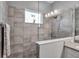 Walk-in shower with neutral tile and glass enclosure at 12915 True Blue Cir, Bradenton, FL 34211