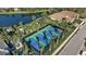 Community tennis courts near lake and homes at 12915 True Blue Cir, Bradenton, FL 34211