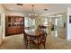 Dining room with kitchen view, wooden table and chairs, and a built-in hutch at 1314 64Th W St, Bradenton, FL 34209