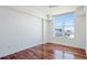 Bright bedroom with hardwood floors and large window offering an outdoor view at 1350 Main St # 1302, Sarasota, FL 34236