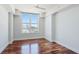 Bright bedroom featuring hardwood floors and a large window at 1350 Main St # 1302, Sarasota, FL 34236