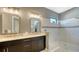 Double vanity bathroom with walk-in shower and modern fixtures at 13947 Messina Loop, Bradenton, FL 34211