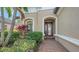 Inviting entryway with a red door and brick walkway at 13947 Messina Loop, Bradenton, FL 34211