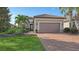 One-story home with tile roof, two-car garage, and landscaped yard at 13947 Messina Loop, Bradenton, FL 34211