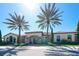 Community clubhouse exterior with lush landscaping and palm trees at 13947 Messina Loop, Bradenton, FL 34211