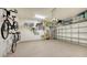 Organized garage with bike storage, shelving, and epoxy flooring at 13947 Messina Loop, Bradenton, FL 34211