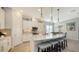 Bright kitchen featuring an island, white cabinets, and pendant lighting at 13947 Messina Loop, Bradenton, FL 34211