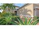 Landscaped entry with lush tropical plants and brick pavers at 13947 Messina Loop, Bradenton, FL 34211