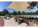 Community patio with shaded seating area, tables, and pickleball courts in the background at 13947 Messina Loop, Bradenton, FL 34211