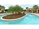 Relaxing freeform pool with lush landscaping and a covered seating area at 13947 Messina Loop, Bradenton, FL 34211