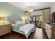 Serene bedroom with a large bed, light walls and hardwood floors at 1423 Landings Pl # 59, Sarasota, FL 34231