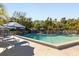 Inviting community pool with lounge chairs and umbrellas at 1423 Landings Pl # 59, Sarasota, FL 34231