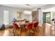 Bright dining room featuring hardwood floors and modern glass table at 1423 Landings Pl # 59, Sarasota, FL 34231