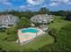 Aerial view of community pool, homes, and lush landscape at 16 Tidy Island Blvd # 16, Bradenton, FL 34210