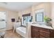 Bathroom features a built-in tub, wood vanity, and window at 16 Tidy Island Blvd # 16, Bradenton, FL 34210