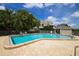 Community pool with brick deck and surrounding landscaping at 16 Tidy Island Blvd # 16, Bradenton, FL 34210