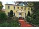 Yellow two-story house with red brick pathway at 1621 Clower Creek Dr # Tr173, Sarasota, FL 34231