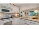 White kitchen with gray countertops and stainless steel appliances at 1621 Clower Creek Dr # Tr173, Sarasota, FL 34231