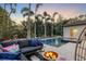 Relaxing backyard with pool, fire pit, and patio furniture at 1718 Prospect St, Sarasota, FL 34239