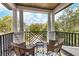 Relaxing balcony with wicker chairs and scenic backyard view at 1718 Prospect St, Sarasota, FL 34239