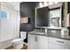 Stylish bathroom with dark walls, a white vanity, and a walk-in shower at 1718 Prospect St, Sarasota, FL 34239