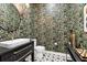 Modern powder room with patterned tile floor and tropical wallpaper at 1718 Prospect St, Sarasota, FL 34239