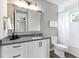 Clean bathroom with white subway tiles, a soaking tub, and modern vanity at 1718 Prospect St, Sarasota, FL 34239