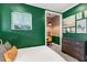 Cozy bedroom with a built-in workspace and green accent wall at 1718 Prospect St, Sarasota, FL 34239