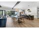 Open concept dining area with a long wooden table and modern chairs, overlooking the kitchen and pool at 1718 Prospect St, Sarasota, FL 34239