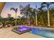 Illuminated pool and spa at night, creating a serene ambiance at 1718 Prospect St, Sarasota, FL 34239