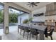 Outdoor kitchen with stainless steel appliances and dining area, overlooking a pool at 1718 Prospect St, Sarasota, FL 34239