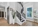 Elegant staircase with black metal railing and white risers at 1718 Prospect St, Sarasota, FL 34239