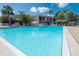 Community pool with ample lounge chairs at 1801 Gulf N Dr # 175, Bradenton Beach, FL 34217