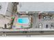 Aerial view of resort-style pool, parking lot, and surrounding buildings at 19610 Gulf Blvd # 303, Indian Shores, FL 33785